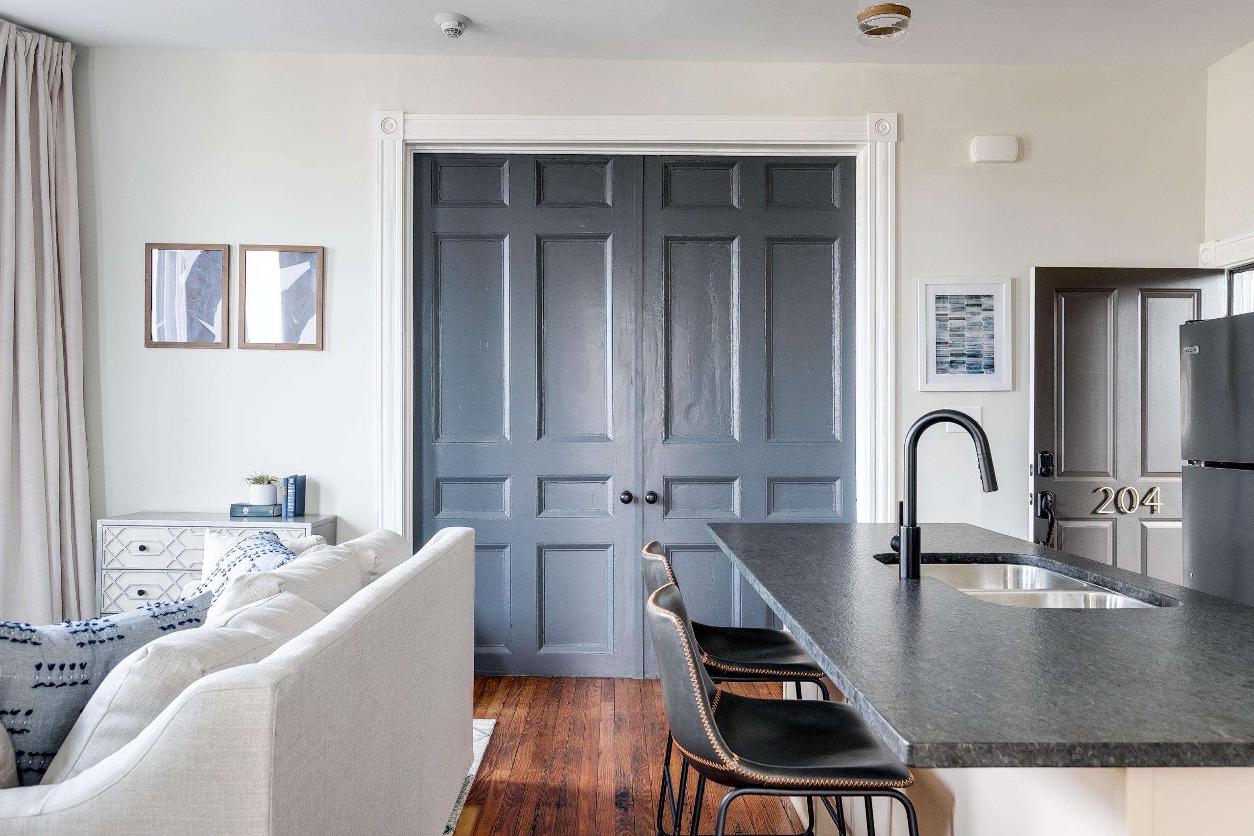Massive blue/gray French doors that give a modern yet classic feel to the living space.
